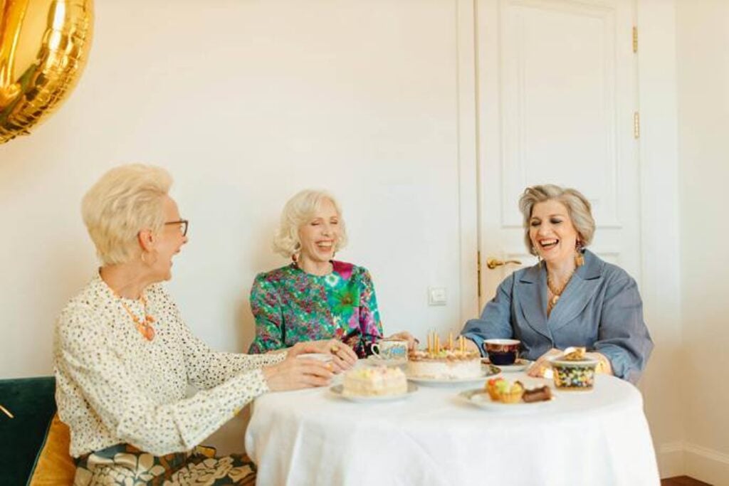 senior women chatting cheerfully around a coffee table