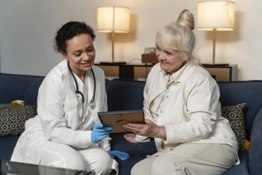 A woman (50s, diverse) sitting with a healthcare provider (also diverse) in a bright, modern office, both looking at a tablet or document, engaged in a calm discussion