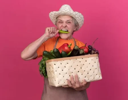 Person with a warm smile holding a basket of fresh, colorful market vegetables, symbolizing healthy choices and a vibrant lifestyle for diabetes type 2 nutrition management