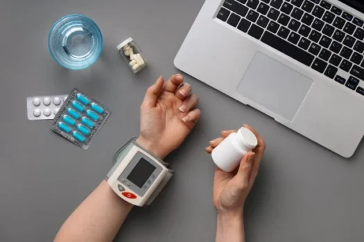 a woman hand measuring her blood sugar with supplements as a supportive element.