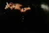 A couple’s soft, backlit silhouette about to kiss, with warm tones and gentle blur.