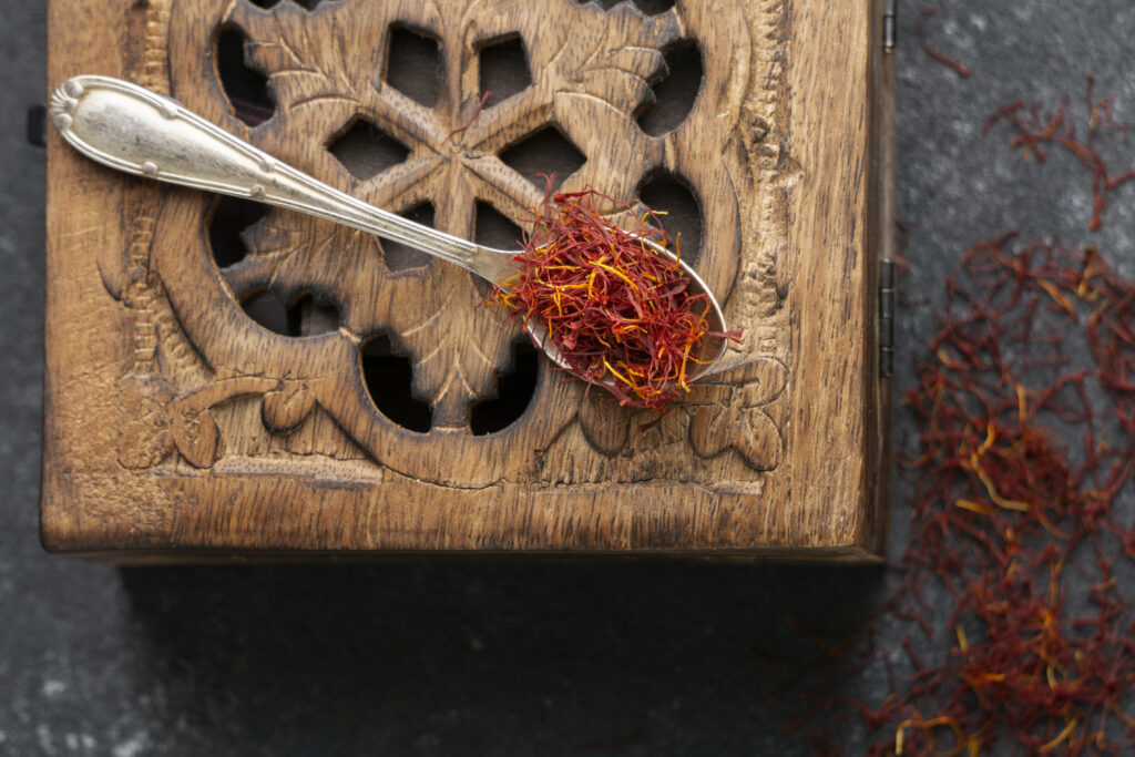 Saffron threads and a simple supplement bottle on soft linen, suggesting natural support for female sexual health supplements