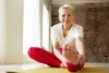 An active woman after menopause does morning stretches to support bone health.