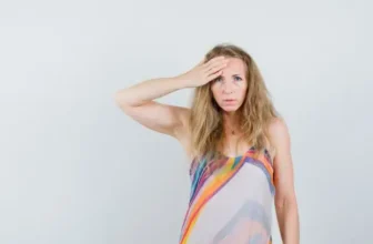 Woman experiencing night sweats and hot flashes causing sleep disturbance during perimenopause