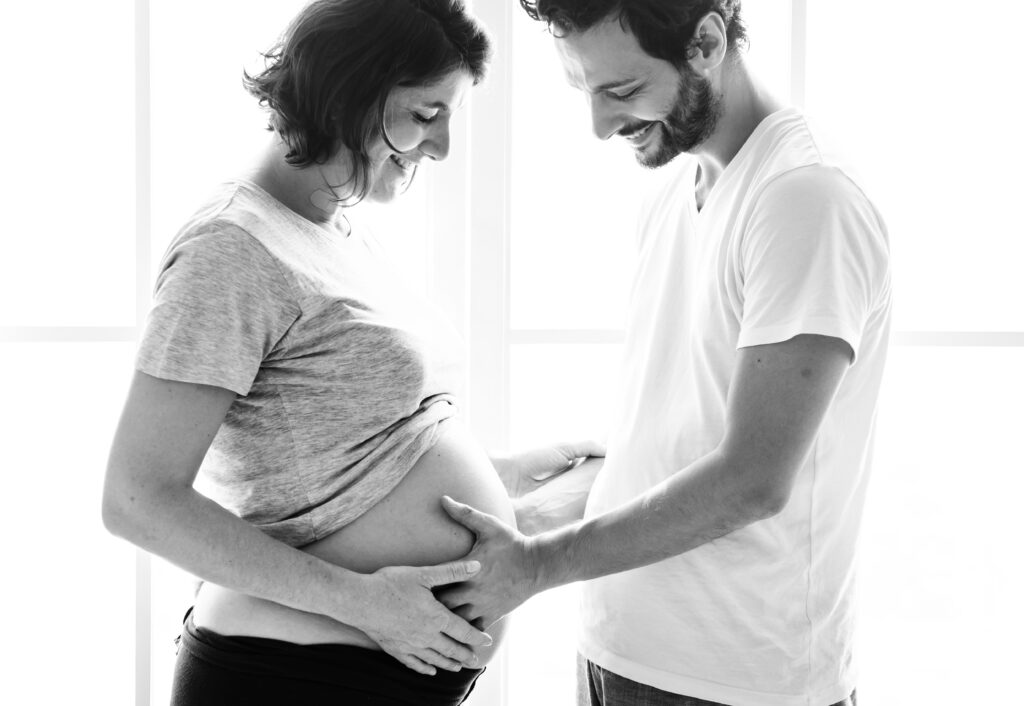 A pregnant woman expecting twins with her husband
